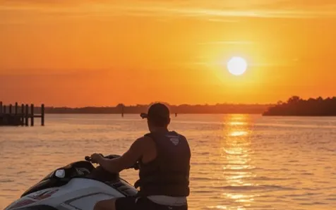 Rider silhouetted against a Gulf sunset